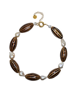 Necklace with brown oval beads and white pearls on a white background