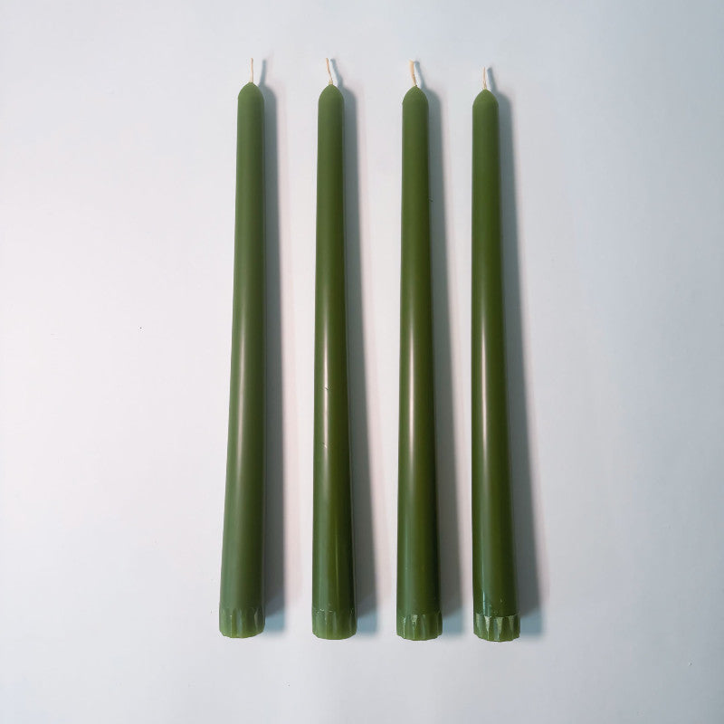 Five green candles of varying heights on a white background