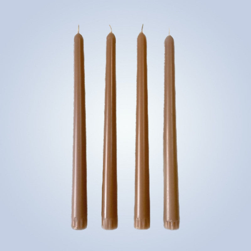 Four golden pear candles of varying lengths on a light blue background