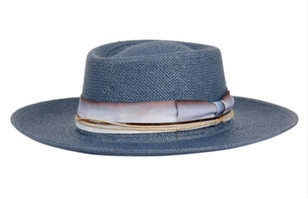 Blue straw hat with decorative band on a white background