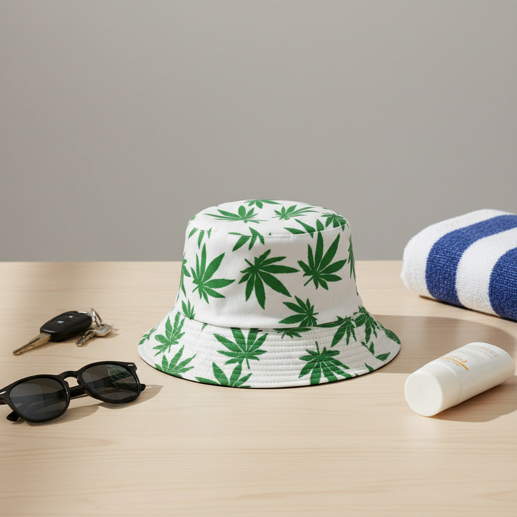 White bucket hat with green cannabis leaf pattern on a white background