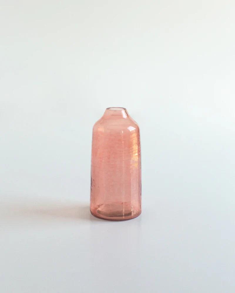 Pink glass vase on a light gray background