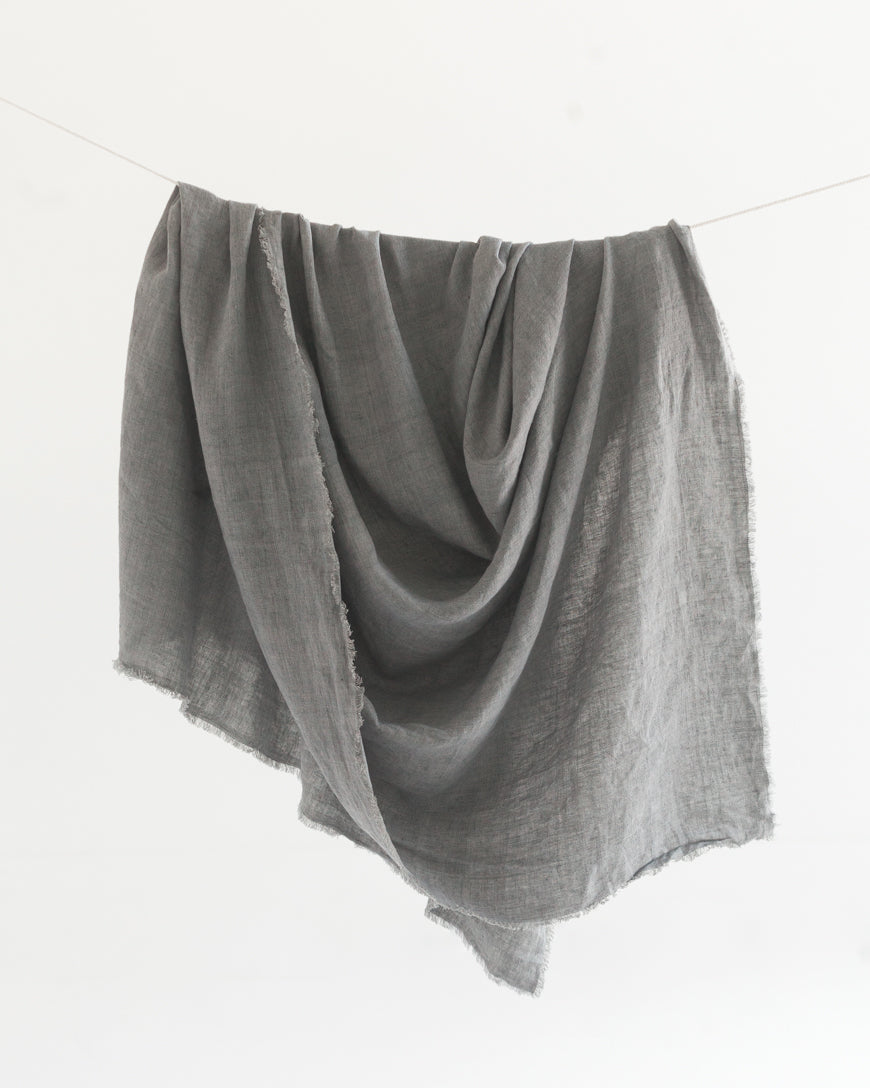 Gray fabric draped over a white background