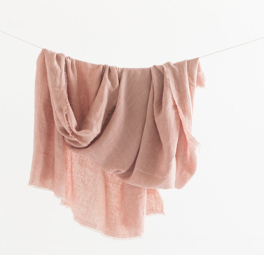 Pink fabric draped over a white background