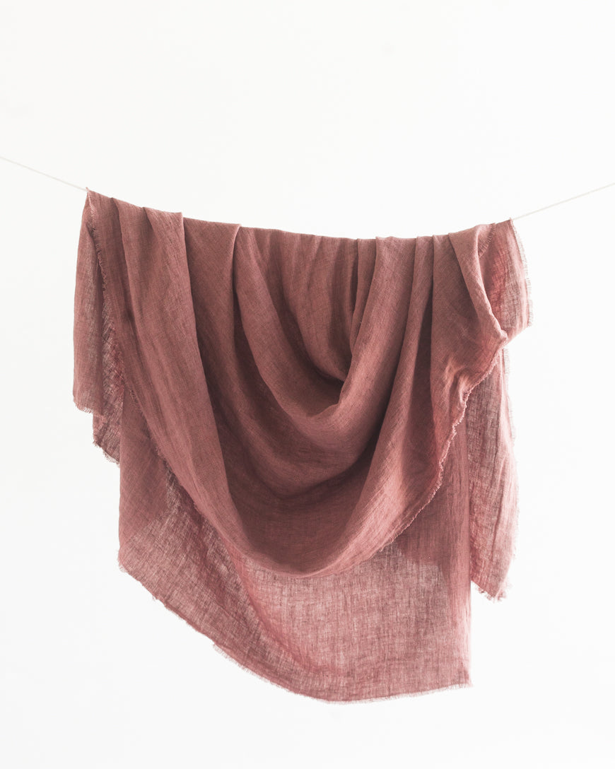 Pink textured fabric draped over a white background