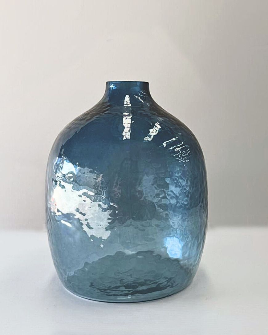 Blue glass vase on a white background