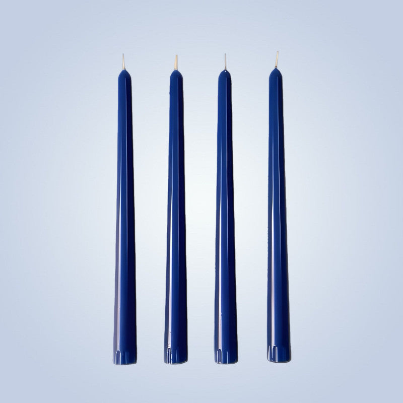 Four dark blue candles on a light blue background
