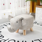 Gray elephant-shaped ottoman on a white floor with decorative elements in the background