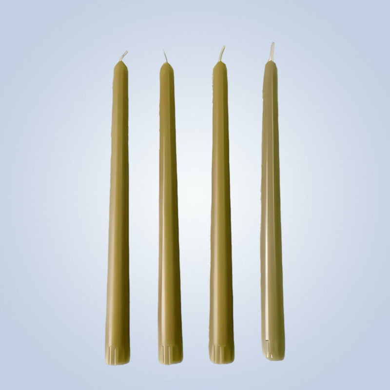 Four green candles on a light blue background